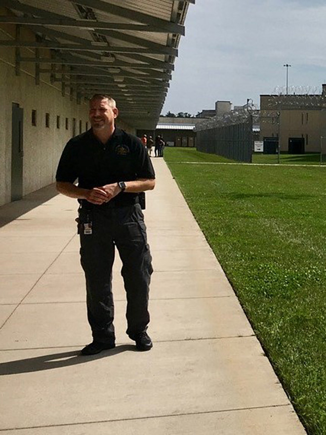 David Jankoviak stands outside in a police uniform.