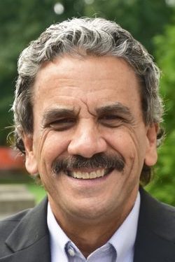 Professional headshot for Dr. Thomas DeGeorge, faculty and staff member of the graduate counseling program at Rosemont College. He is a white man with grey hair and a dark moustache.